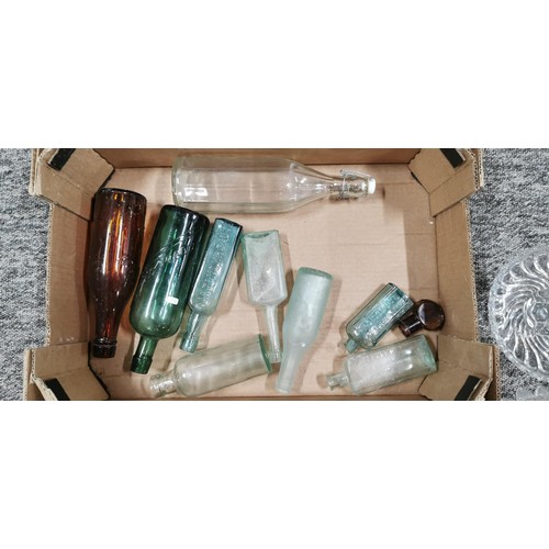 84 - A quantity of collectable glass bottles and other glassware, a new sealed double bed sheet, DVD's re... 