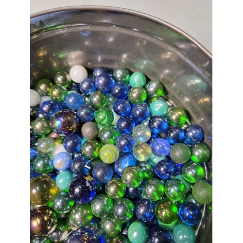 46 - A tub of modern marbles mostly are iridescent solid colours all in good condition.