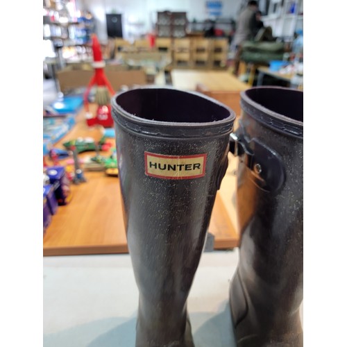 192 - A pair of Hunter Wellington boots and a pair of Sketchers, both pairs in size 4.