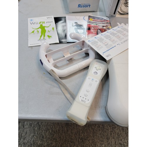 193 - Nintendo Wii with motion plus Wii remote, steering wheel, Wii fit board and Wii Fit Resort game disk... 