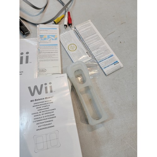 193 - Nintendo Wii with motion plus Wii remote, steering wheel, Wii fit board and Wii Fit Resort game disk... 