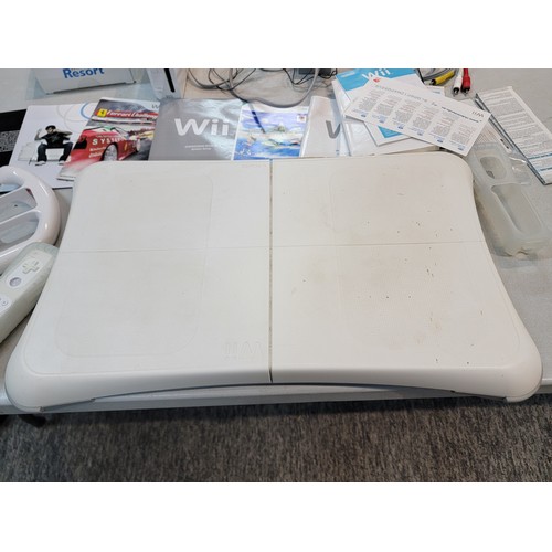 193 - Nintendo Wii with motion plus Wii remote, steering wheel, Wii fit board and Wii Fit Resort game disk... 