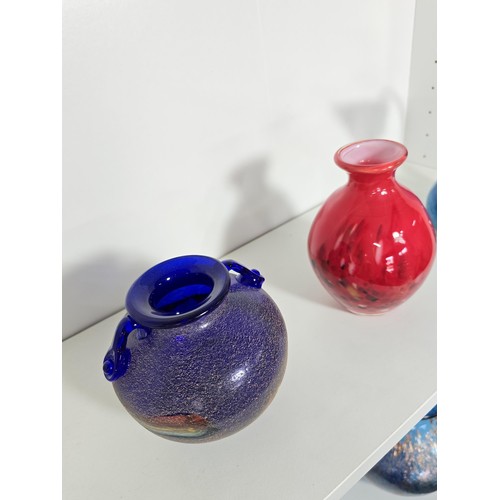 98 - A quantity of 4 studio art glass items including a mottled red vase, a blue glass jug with an ocean ... 