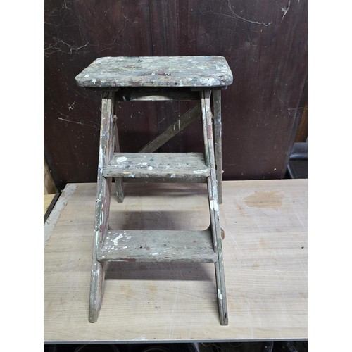 119 - A vintage fold away wooden 2 step ladder, still with its original makers sticker.