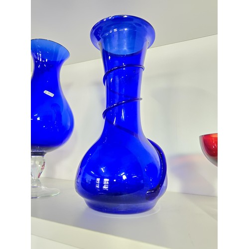 105 - A collection of 4x art glass vases to include a hand blown tall blue glass vase with a swirl design,... 