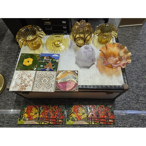 108 - A collection of amber glass and collectable tiles which includes a vintage hand blown Murano amber g... 