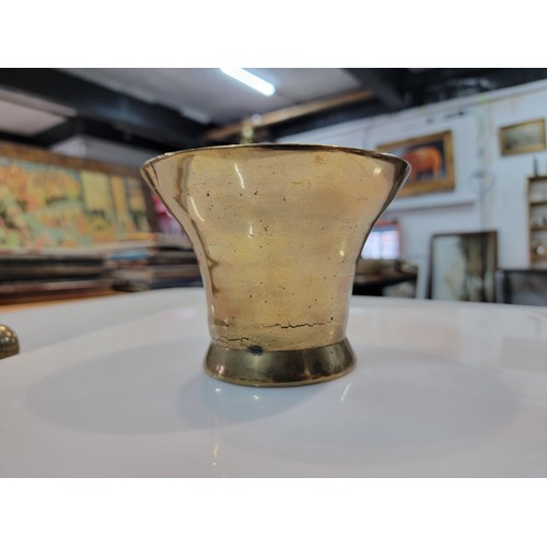 216 - A good quality solid bronze mortar and pestle has a casting crack to the base otherwise in overall g... 