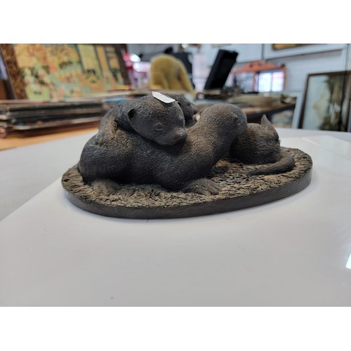 218 - Cast resin figurine of a family of otters in good order 10cm high 24cm long