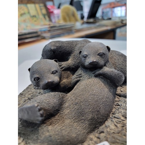 218 - Cast resin figurine of a family of otters in good order 10cm high 24cm long