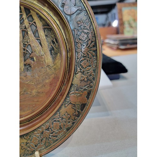 221 - Vintage metal dish with bronze effect depicting a hunting boar scene to the centre with horse relate... 