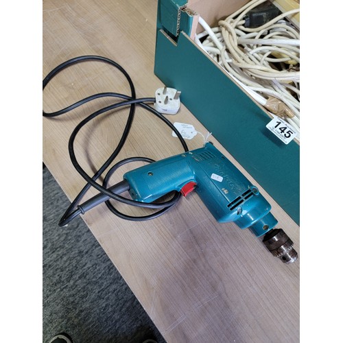 145 - Box containing a quantity of electrical extension cables along with a Makita electric drill