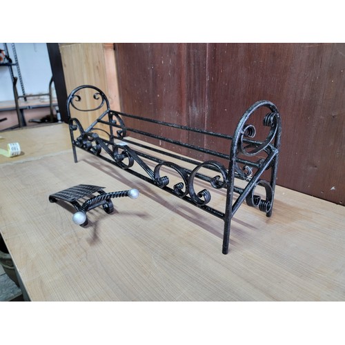 159 - Wrought iron boot stand with scroll design to the front and sides along with a wrought iron boot jac... 