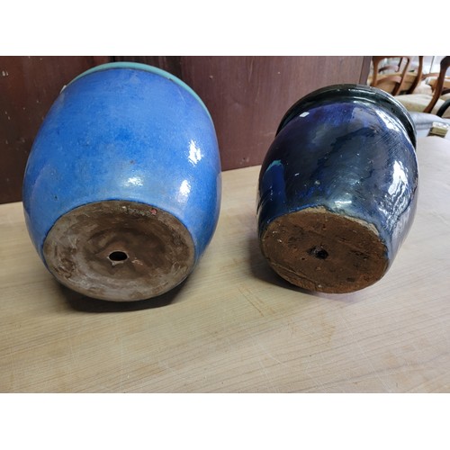 170 - 2x glazed blue planters. 1x in terracotta and the other in concrete, both in good order. Largest sta... 