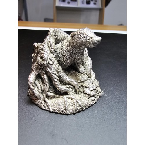 338 - A hallmarked silver badger figure coming out of a tree stump by Country Artists, also signed to the ... 