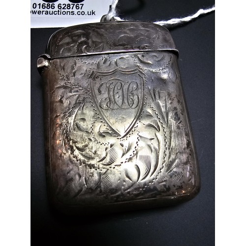 339 - A hallmarked silver antique vesta case featuring an engraved design having a shield cartouche to the... 