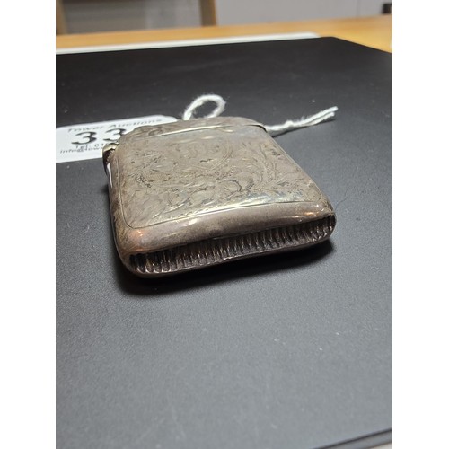 339 - A hallmarked silver antique vesta case featuring an engraved design having a shield cartouche to the... 