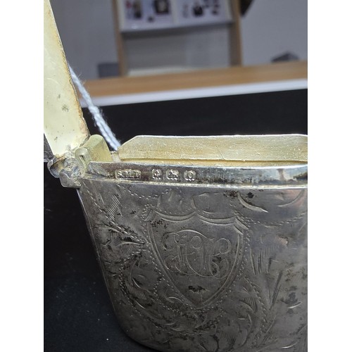 339 - A hallmarked silver antique vesta case featuring an engraved design having a shield cartouche to the... 