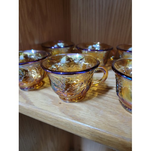 370 - Large collection of 12x carnival glass cups, all cups have a moulded leaf design to the sides, all i... 