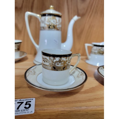 375 - A 3 person Noritake black cream and gilded coffee set with 3x coffee cans and saucers, cream jug, su... 