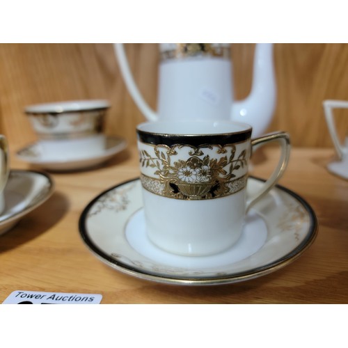 375 - A 3 person Noritake black cream and gilded coffee set with 3x coffee cans and saucers, cream jug, su... 