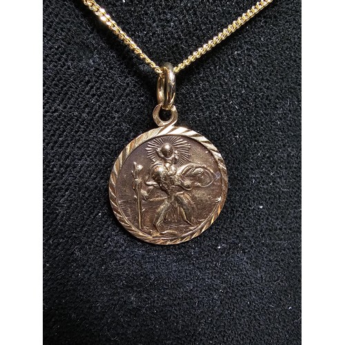 345 - A hallmarked 9ct yellow gold St Christopher pendant set on a 20