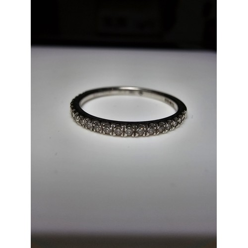 348 - A hallmarked 9ct white gold diamond ring inset with 7 diamonds to the centre with several small diam... 