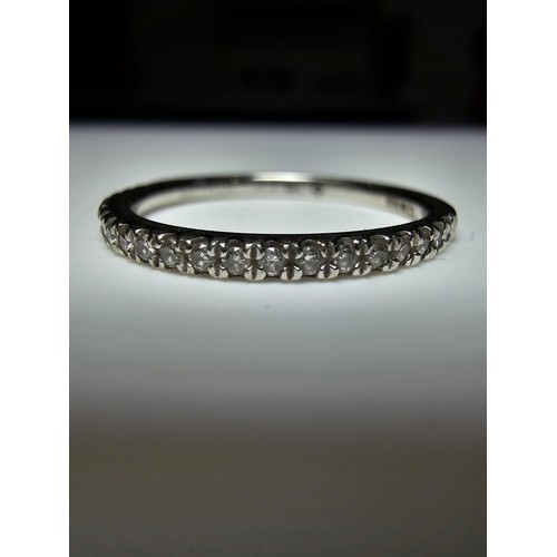 348 - A hallmarked 9ct white gold diamond ring inset with 7 diamonds to the centre with several small diam... 