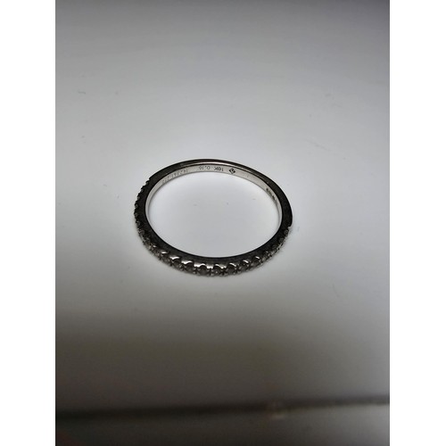 348 - A hallmarked 9ct white gold diamond ring inset with 7 diamonds to the centre with several small diam... 