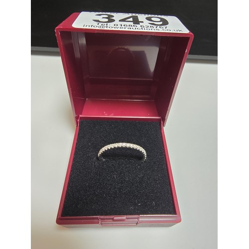 349 - A hallmarked 18ct white gold half eternity ring inset half way around with a large quantity of real ... 