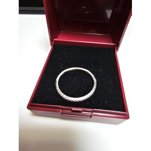 349 - A hallmarked 18ct white gold half eternity ring inset half way around with a large quantity of real ... 