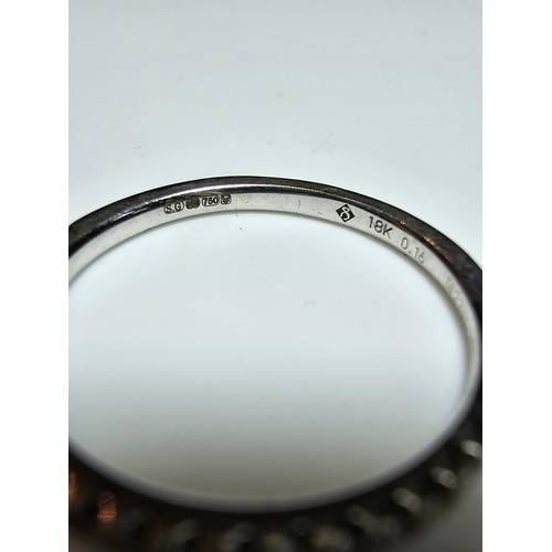 349 - A hallmarked 18ct white gold half eternity ring inset half way around with a large quantity of real ... 