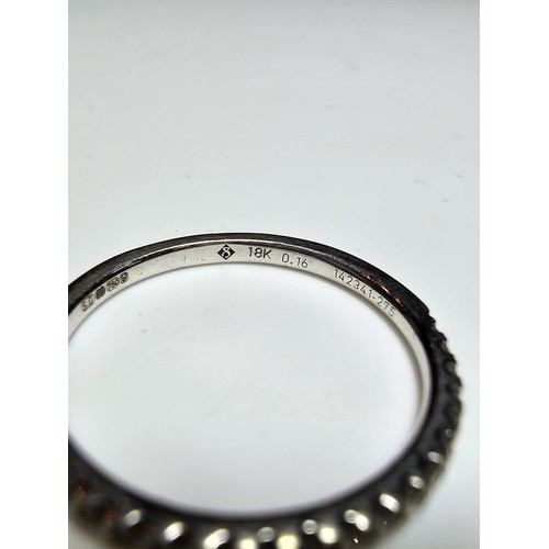 349 - A hallmarked 18ct white gold half eternity ring inset half way around with a large quantity of real ... 