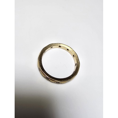 352 - A 9ct yellow gold ring inset with faceted rock crystal stones all the way around, in excellent clean... 