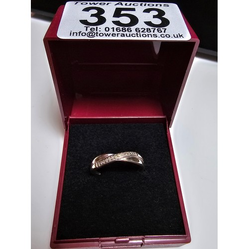 353 - A 9ct white gold crossover style ring inset with a band of diamonds, in excellent clean condition an... 