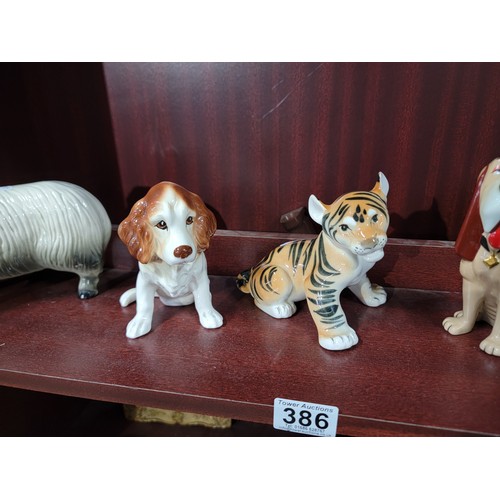 386 - Quantity of collectable figurines inc a good quality Lomonosov Russian tiger figure along with a Wad... 