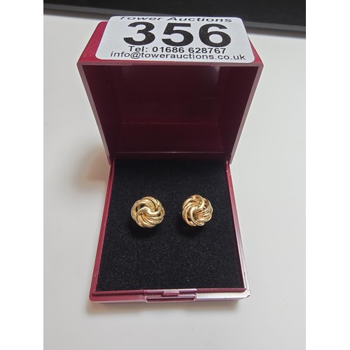 356 - A pair of 9ct yellow gold knot formed stud earrings complete with butterfly backs, in excellent clea... 