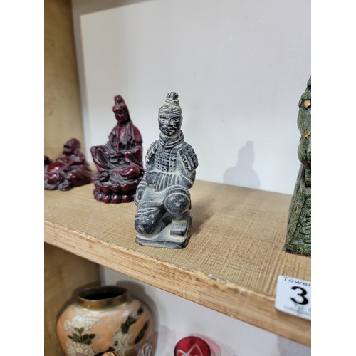 395 - Quantity of resin figurines to inc a small red Buddha, a kneeling Chinese army figure, an Aztec Maya... 