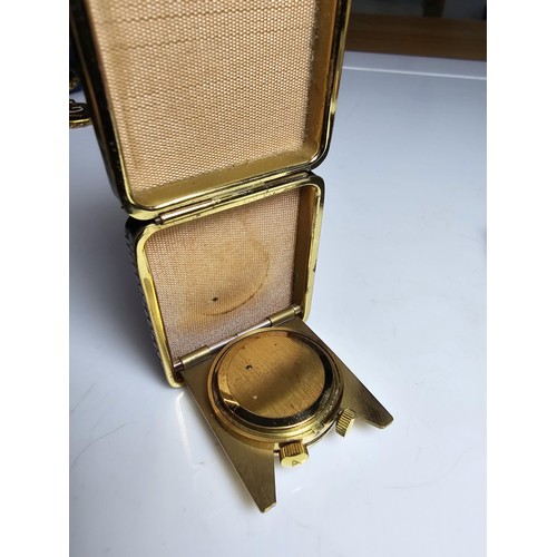 335 - A pretty small cased travel clock with a mechanical movement on a sweeping second hand marked to the... 