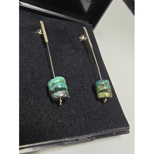 269 - A pair of 925 silver long drop earrings both inset with 3 genuine turquoise beads, in good condition... 