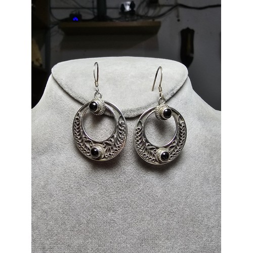 270 - A pair of good quality sterling silver hoop drop earrings with an ornate worked metal design inset w... 