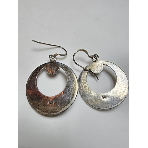 270 - A pair of good quality sterling silver hoop drop earrings with an ornate worked metal design inset w... 