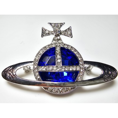 274 - A vintage Vivian Westwood blue orb silver tone brooch having a large blue crystal to the centre surr... 