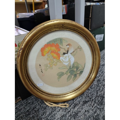 406 - 2x circular framed and glazed silk oriental pictures of birds both are signed along with a large gil... 