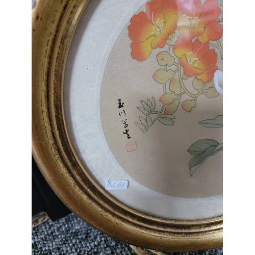 406 - 2x circular framed and glazed silk oriental pictures of birds both are signed along with a large gil... 