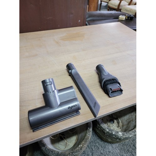 142 - Dyson vacuum cleaner in working order with a quantity of accessories and wall mount, Dyson will requ... 