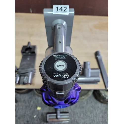 142 - Dyson vacuum cleaner in working order with a quantity of accessories and wall mount, Dyson will requ... 