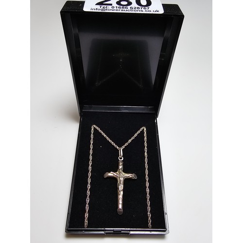 280 - A sterling silver Crucifix pendant set on a long 19