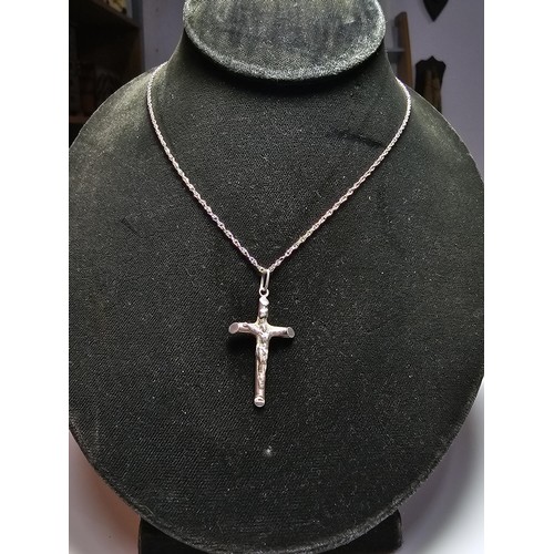 280 - A sterling silver Crucifix pendant set on a long 19