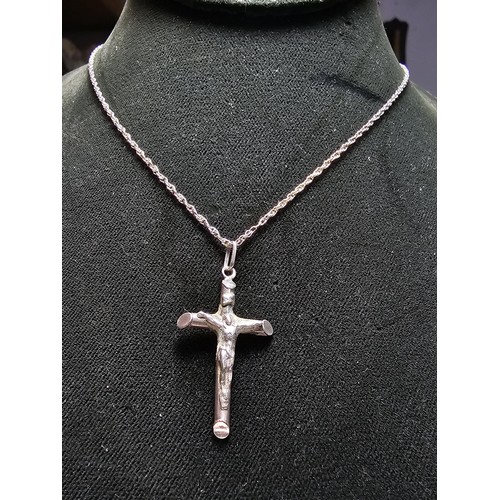 280 - A sterling silver Crucifix pendant set on a long 19