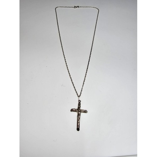 280 - A sterling silver Crucifix pendant set on a long 19